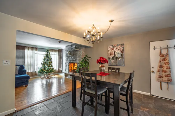 a view of a dining room with furniture and a chandelier