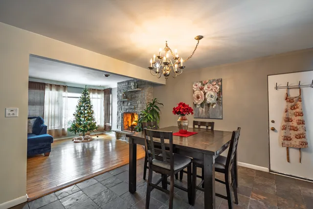 a view of a dining room with furniture and a chandelier
