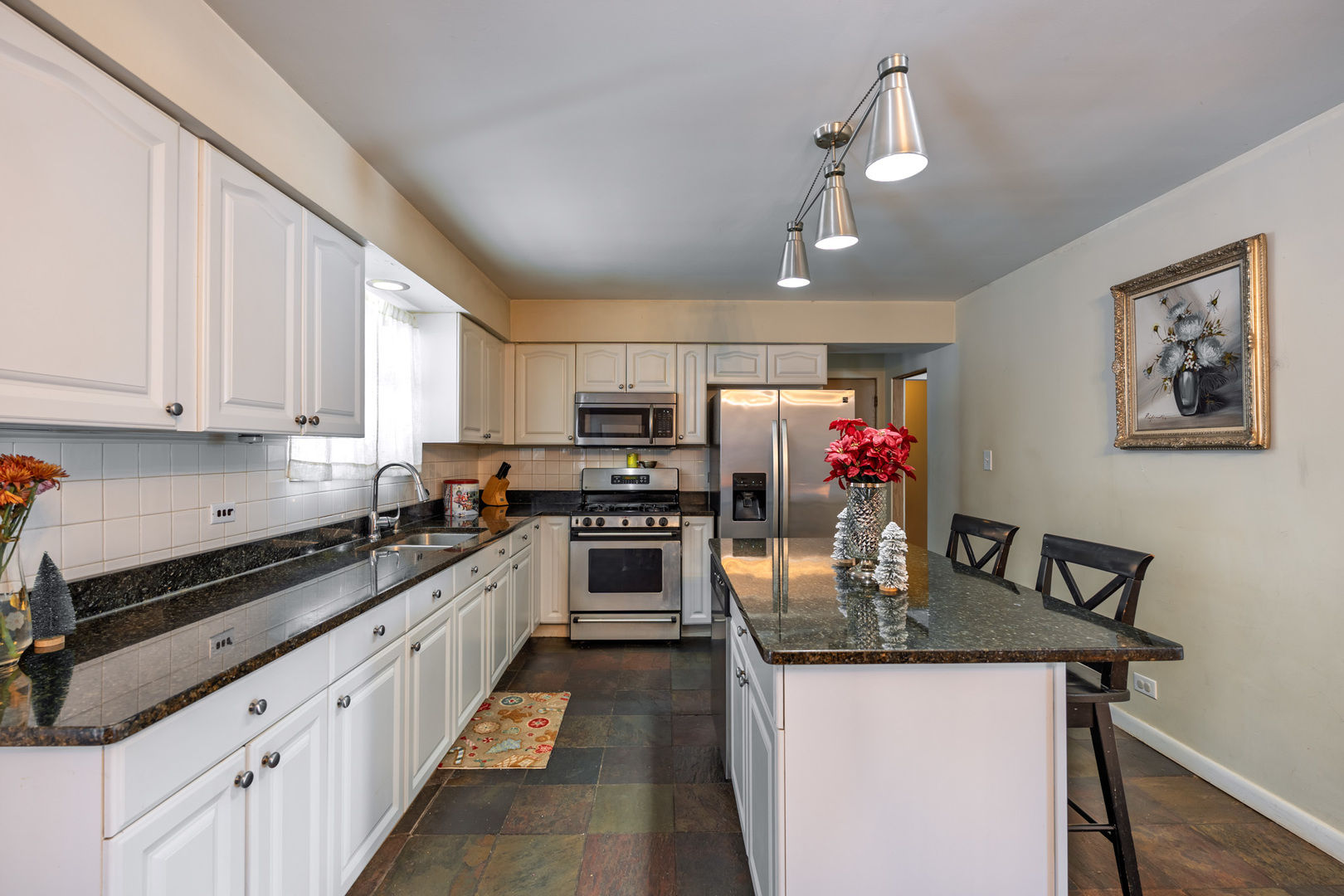 6325 Keokuk Road Indian Head Park, IL 60525 - Photo 8 of 21 a kitchen with kitchen island granite countertop stainless steel appliances lots of counter top space cabinets and a center island