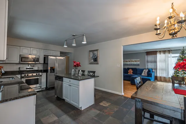 a kitchen with refrigerator and cabinets