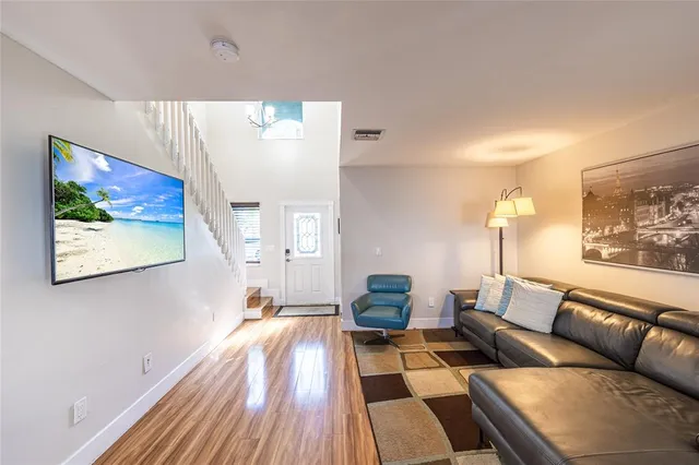 a living room with furniture and wooden floor