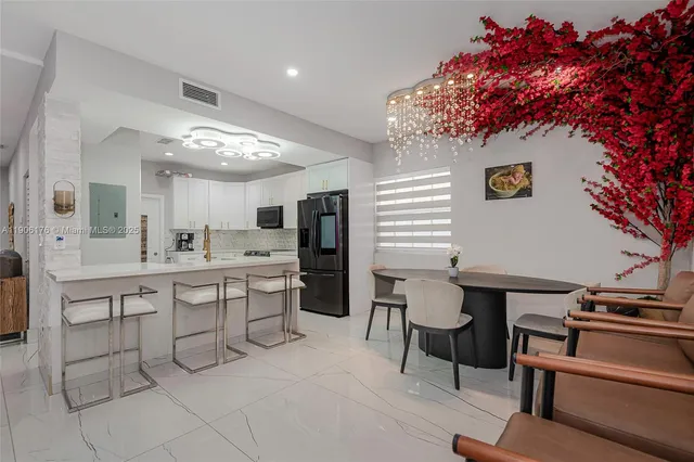 a kitchen with a table and chairs in it