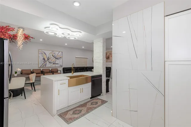 a large white kitchen with a large window