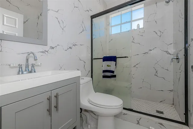 a bathroom with a sink toilet and shower