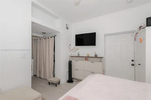 a bedroom with a bed and a flat screen tv