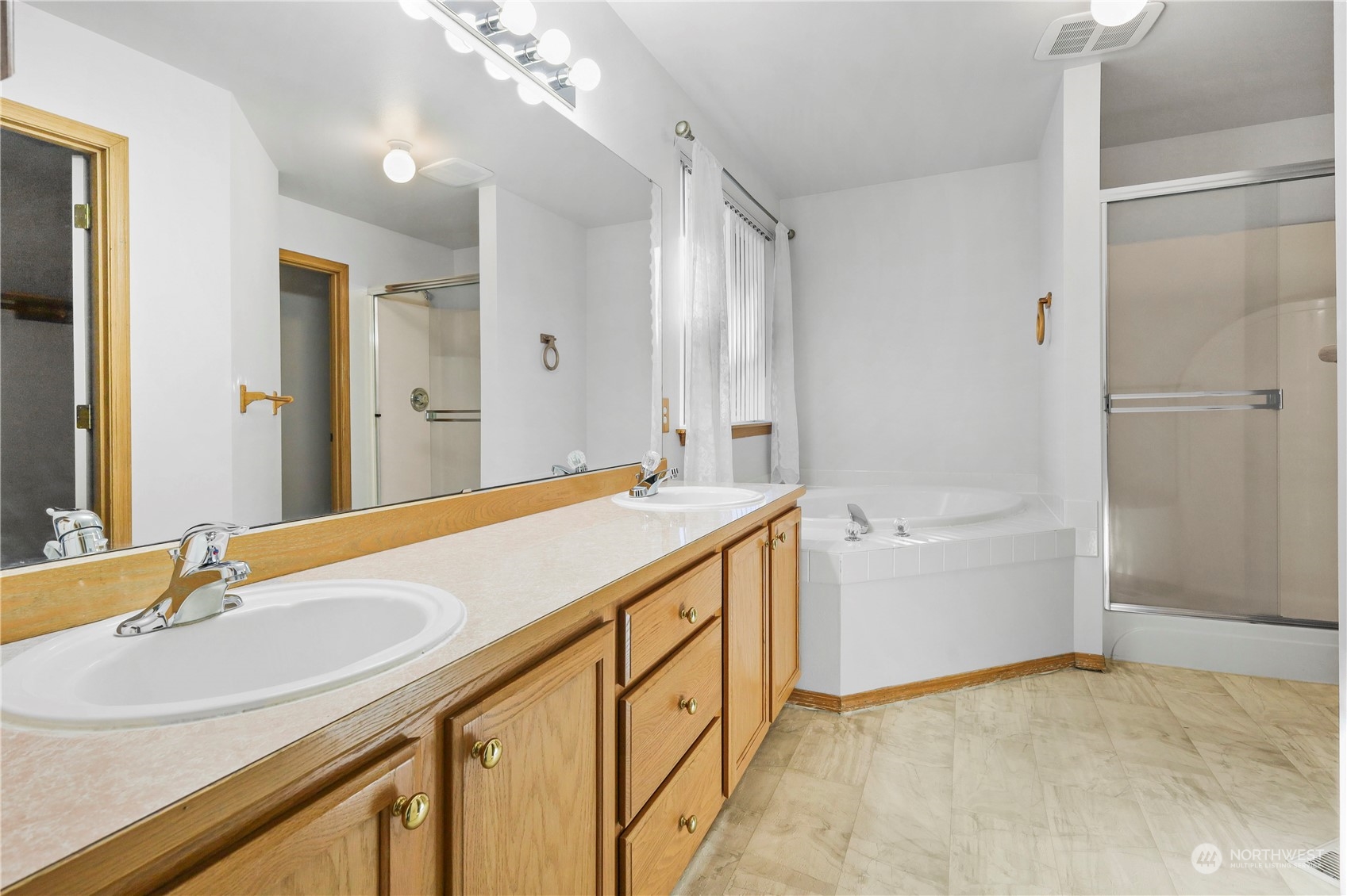 3116 289th Street South Roy, WA 98580 - Photo 20 of 38 a spacious bathroom with a tub sink and mirror