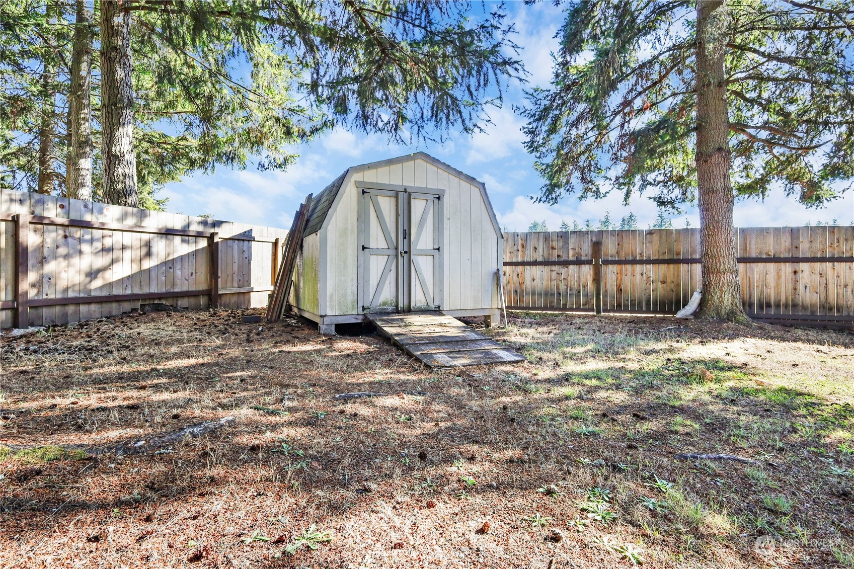 3116 289th Street South Roy, WA 98580 - Photo 27 of 38 a view of a backyard with large tree and wooden fence