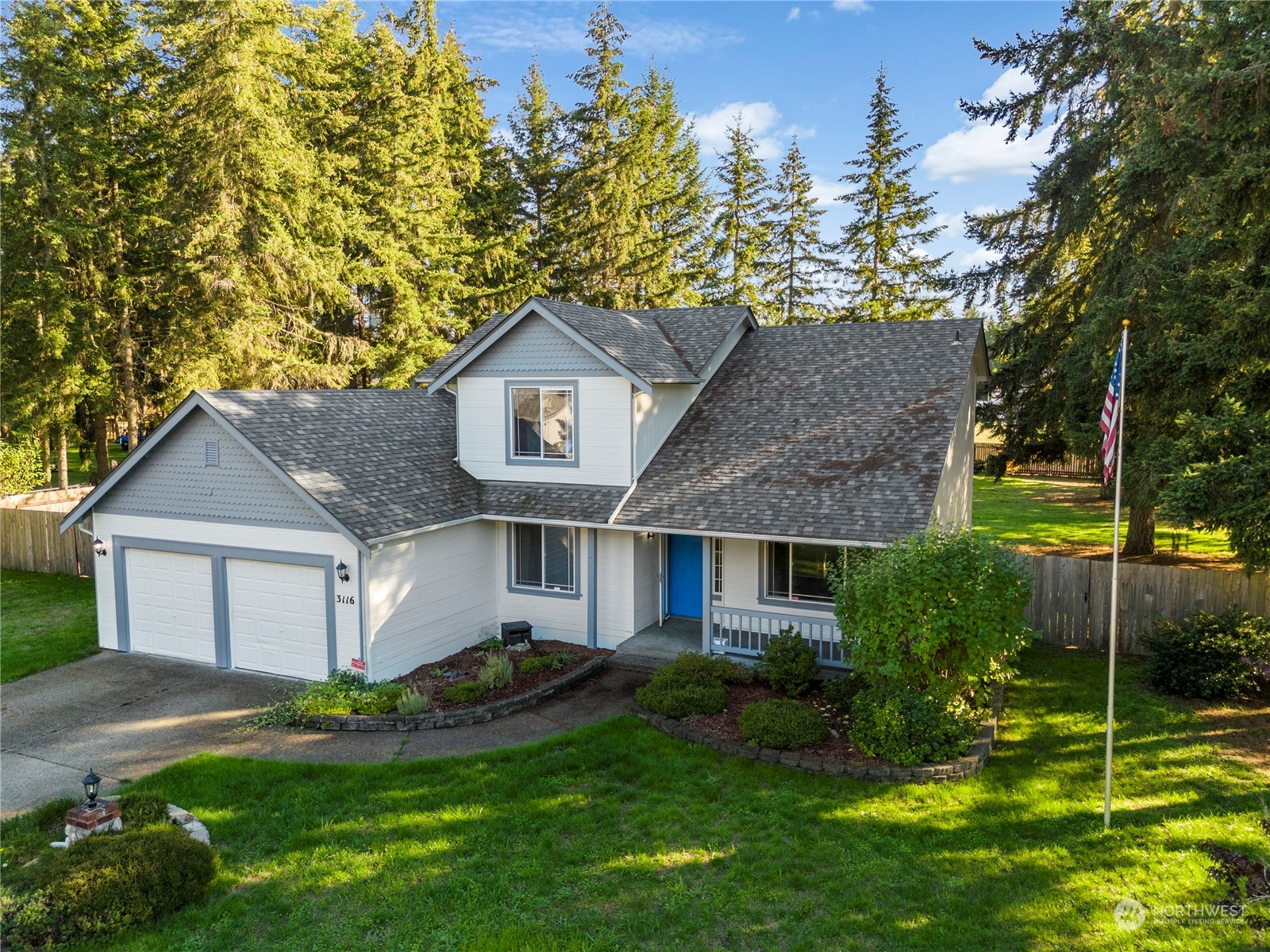 3116 289th Street South Roy, WA 98580 - Photo 29 of 38 a front view of a house with a yard and garage