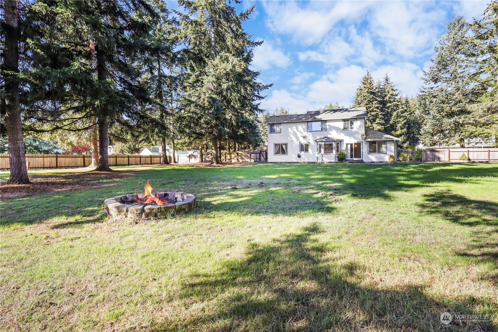 3116 289th Street South Roy, WA 98580 - Photo 31 of 38 a view of a backyard with a garden and trees