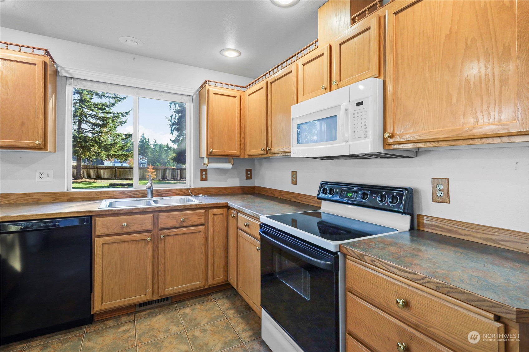 3116 289th Street South Roy, WA 98580 - Photo 7 of 38 a kitchen with a sink stove and cabinets