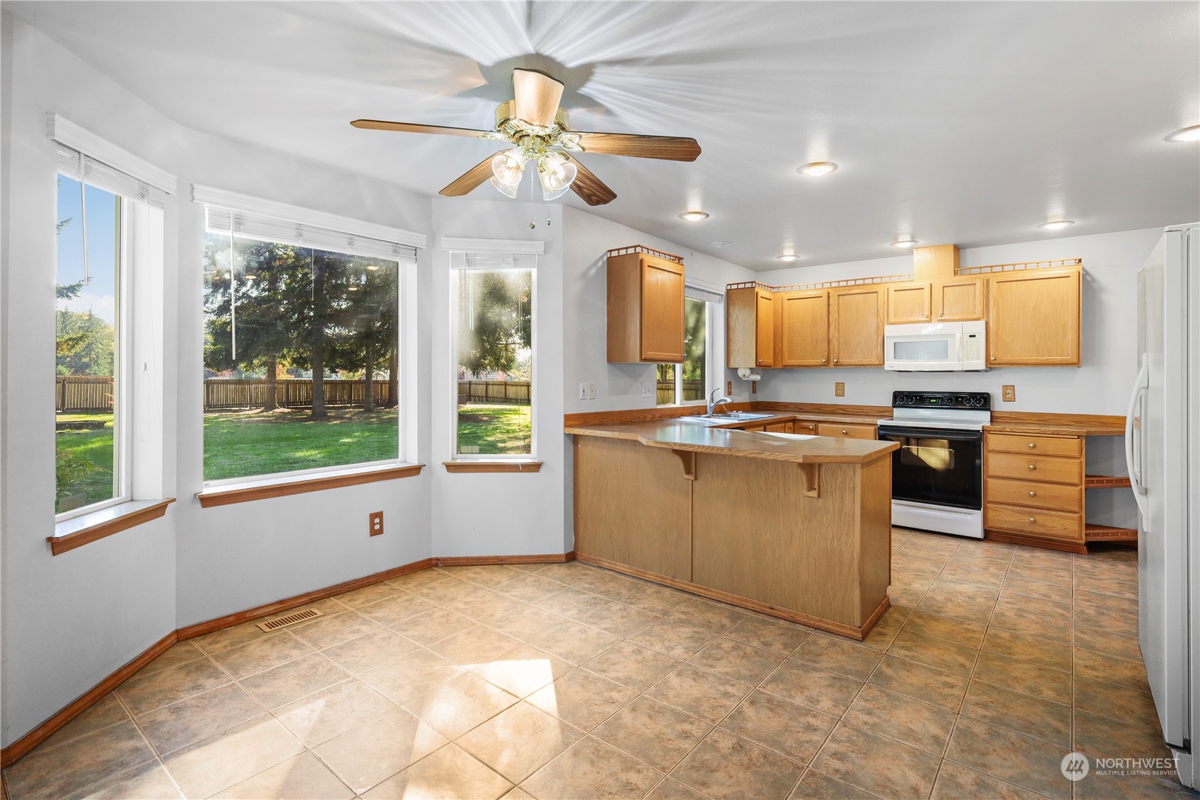 3116 289th Street South Roy, WA 98580 - Photo 10 of 38 a kitchen with stainless steel appliances granite countertop a stove and a refrigerator