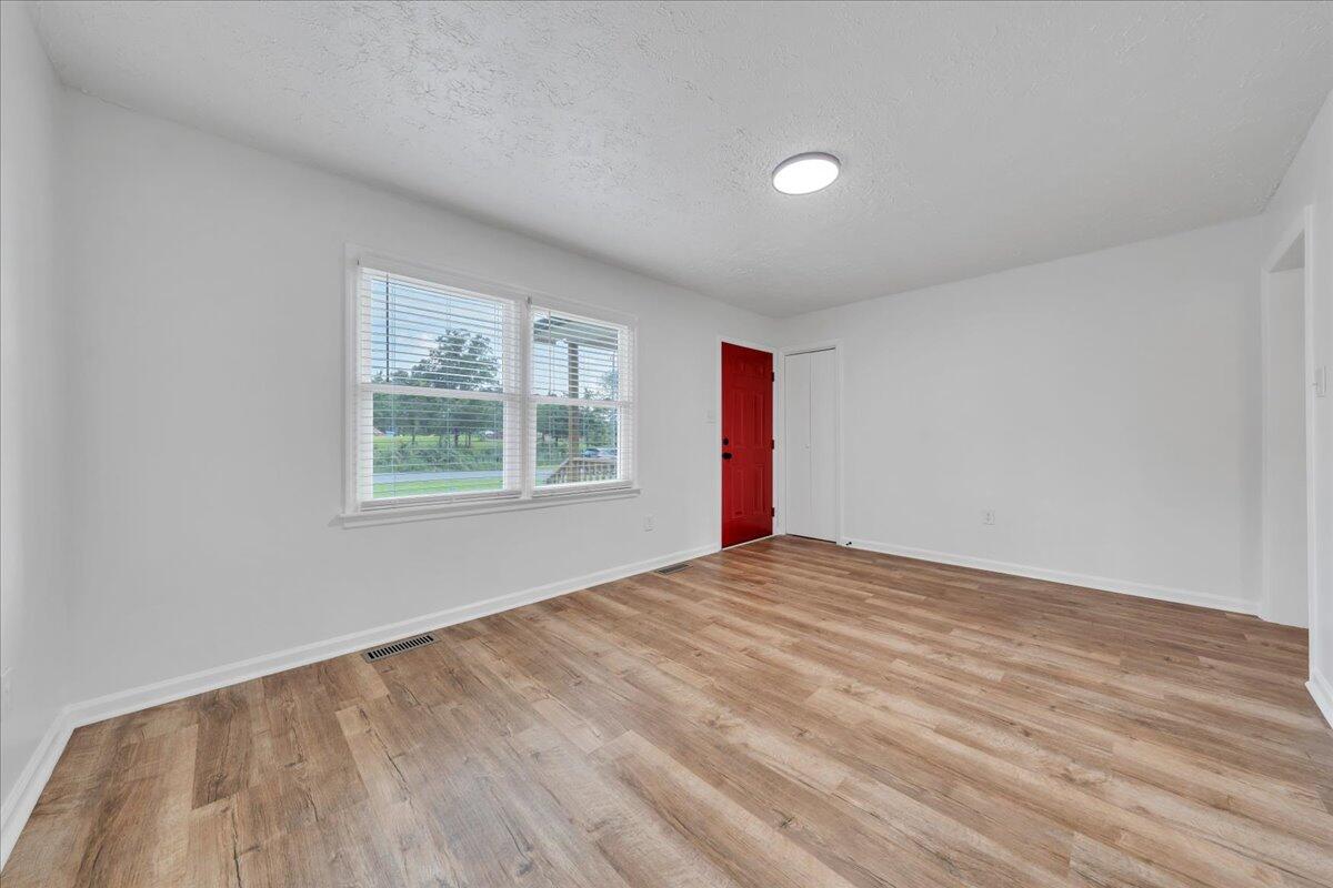 427 Farmington Road Hardy, VA 24101 - Photo 3 of 56 a view of an empty room with wooden floor and a window