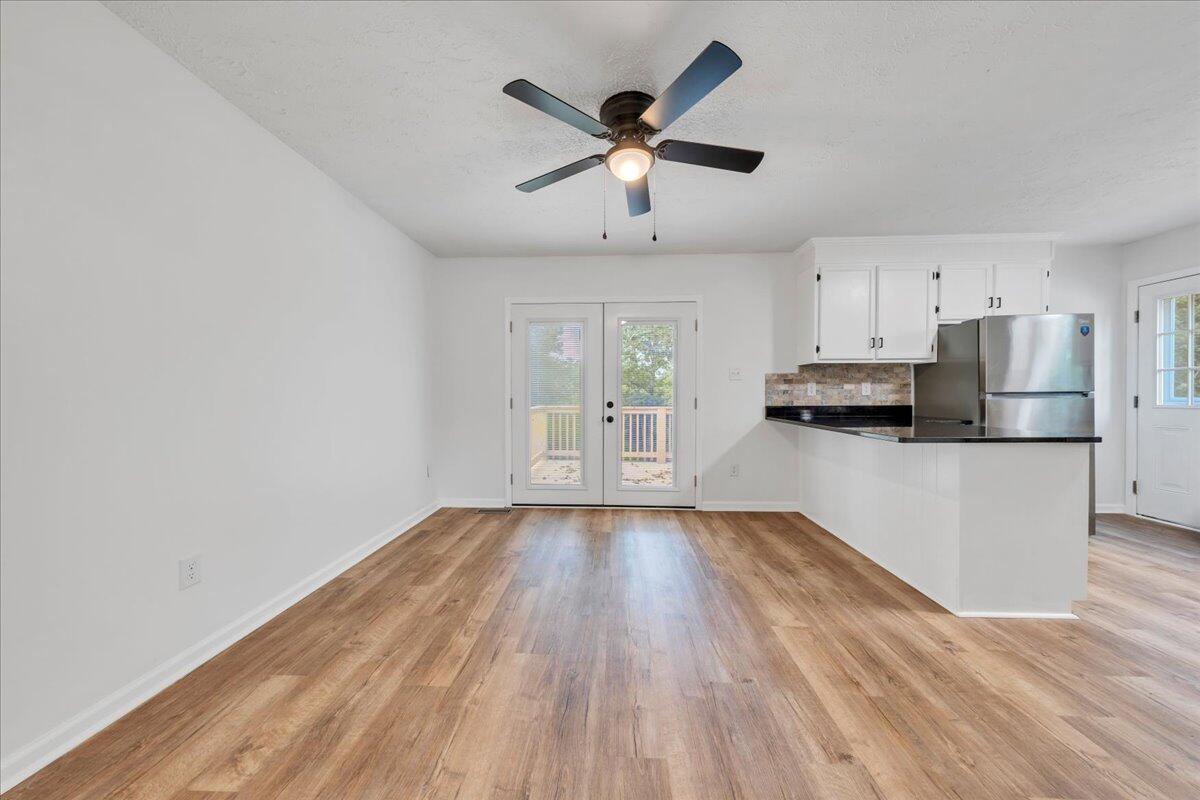 427 Farmington Road Hardy, VA 24101 - Photo 4 of 56 a view of a kitchen with wooden floor and a ceiling fan
