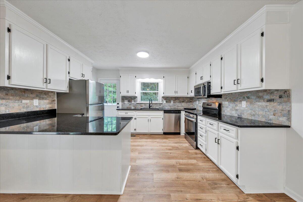 427 Farmington Road Hardy, VA 24101 - Photo 8 of 56 a large kitchen with stainless steel appliances granite countertop a stove a sink and white cabinets