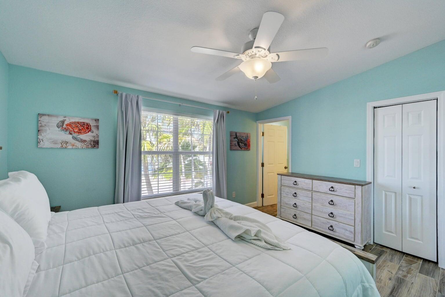 239 Lower Matecumbe Road, Unit 239 Key Largo, FL 33037 - Photo 32 of 69 a bedroom with a large bed and a chandelier