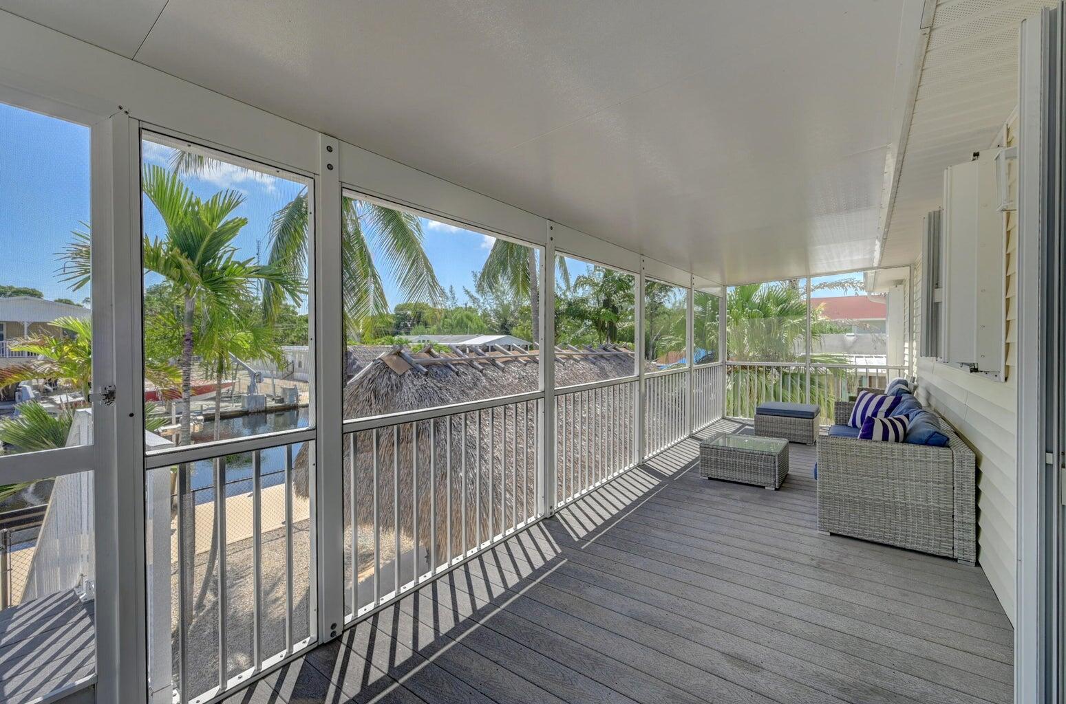 239 Lower Matecumbe Road, Unit 239 Key Largo, FL 33037 - Photo 53 of 69 a living room with furniture and floor to ceiling windows