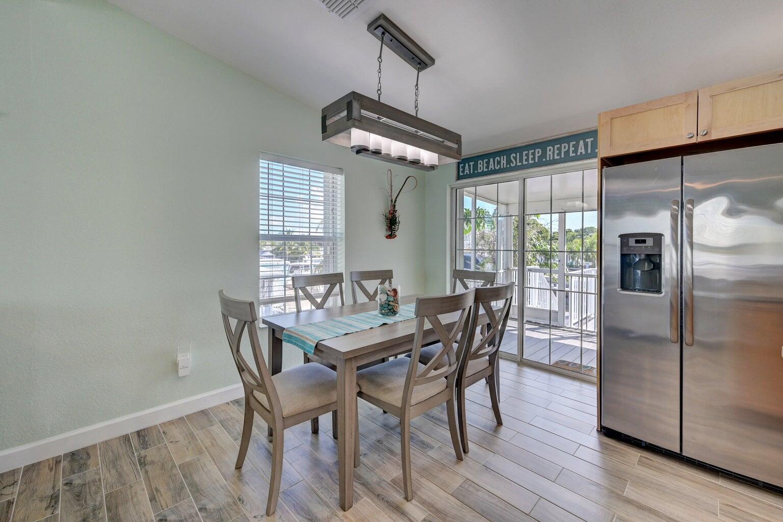 239 Lower Matecumbe Road, Unit 239 Key Largo, FL 33037 - Photo 7 of 69 a view of a dining room with furniture window and wooden floor