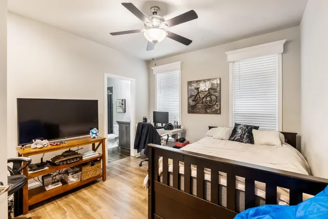 a bedroom with furniture and a flat screen tv