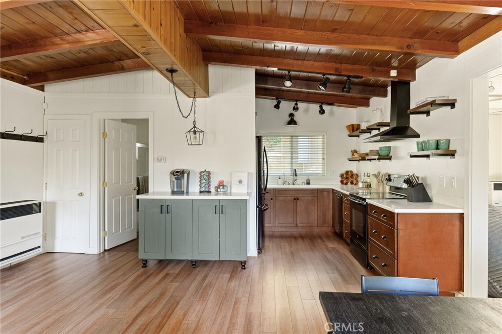 576 Kuffel Canyon Road Lake Arrowhead, CA 92352 - Photo 12 of 61 a kitchen with cabinets a sink and wooden floor