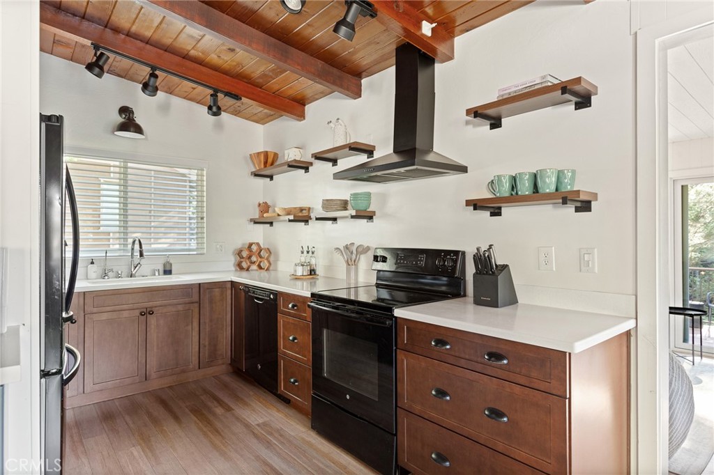 576 Kuffel Canyon Road Lake Arrowhead, CA 92352 - Photo 15 of 61 a kitchen with stainless steel appliances granite countertop a sink a stove and cabinets