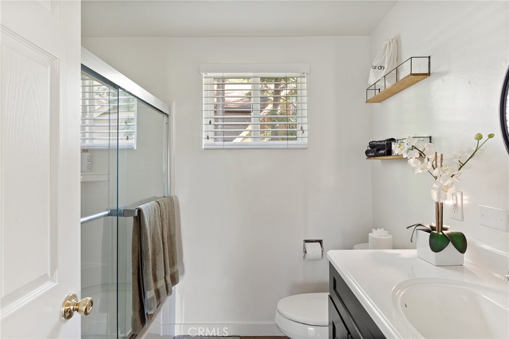 576 Kuffel Canyon Road Lake Arrowhead, CA 92352 - Photo 19 of 61 a bathroom with a granite countertop sink toilet and shower