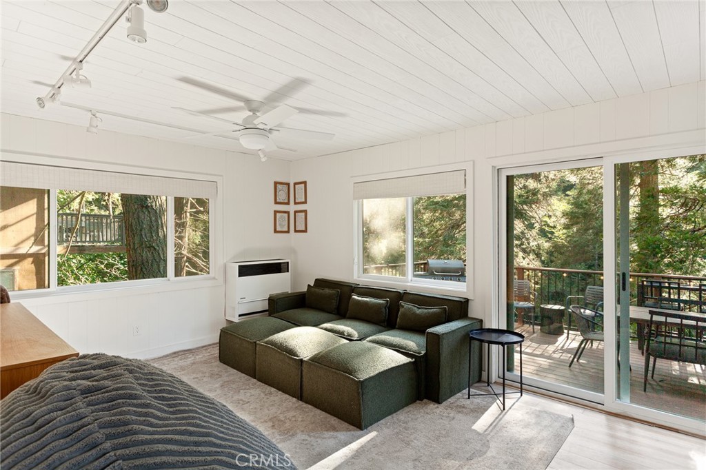 576 Kuffel Canyon Road Lake Arrowhead, CA 92352 - Photo 20 of 61 a living room with furniture and large windows