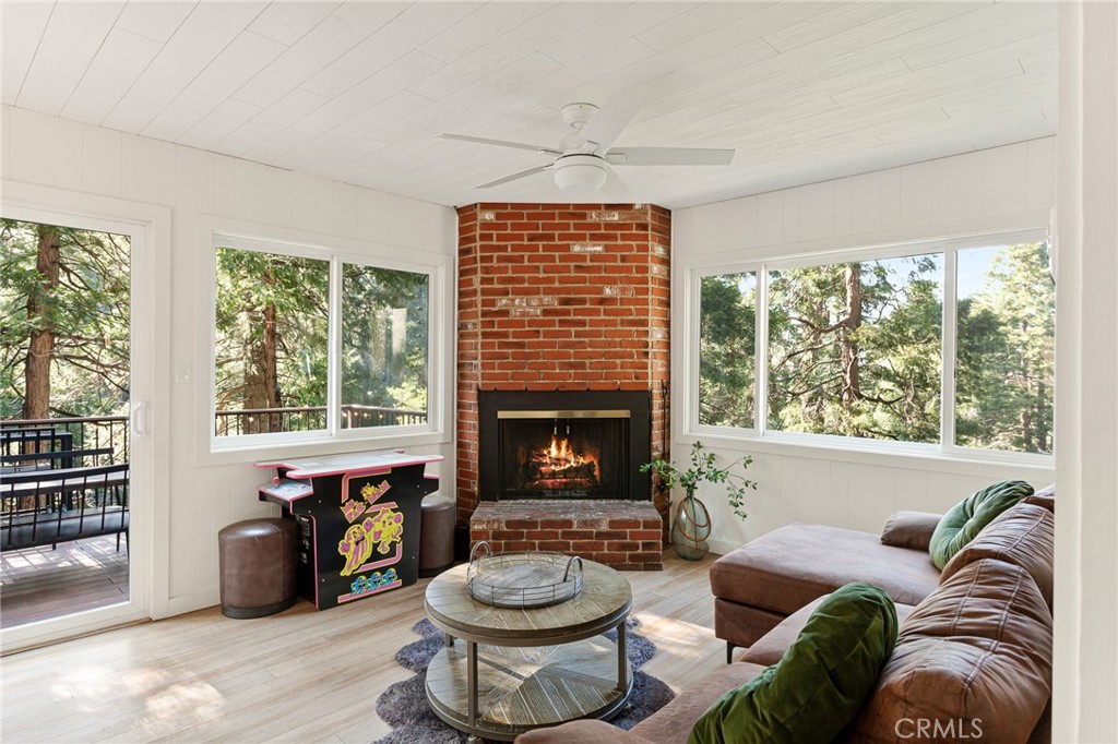 576 Kuffel Canyon Road Lake Arrowhead, CA 92352 - Photo 21 of 61 a living room with furniture and a fireplace