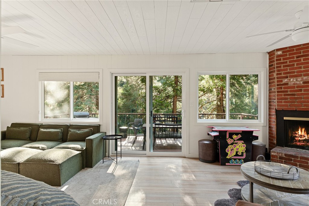 576 Kuffel Canyon Road Lake Arrowhead, CA 92352 - Photo 22 of 61 a living room with furniture and a fireplace