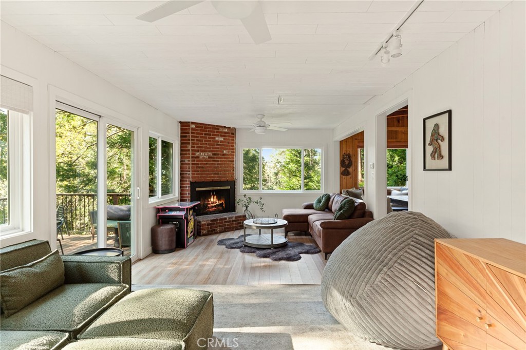 576 Kuffel Canyon Road Lake Arrowhead, CA 92352 - Photo 23 of 61 a living room with furniture large windows and wooden floor