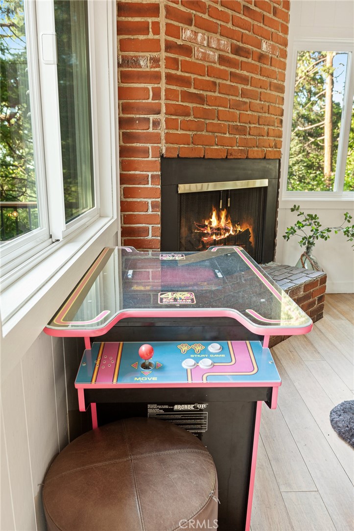 576 Kuffel Canyon Road Lake Arrowhead, CA 92352 - Photo 26 of 61 a room with a fireplace a window and a fireplace