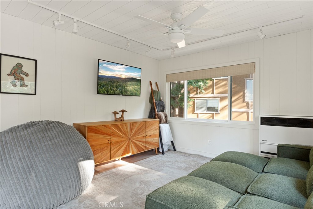 576 Kuffel Canyon Road Lake Arrowhead, CA 92352 - Photo 28 of 61 a living room with a couch and a flat screen tv