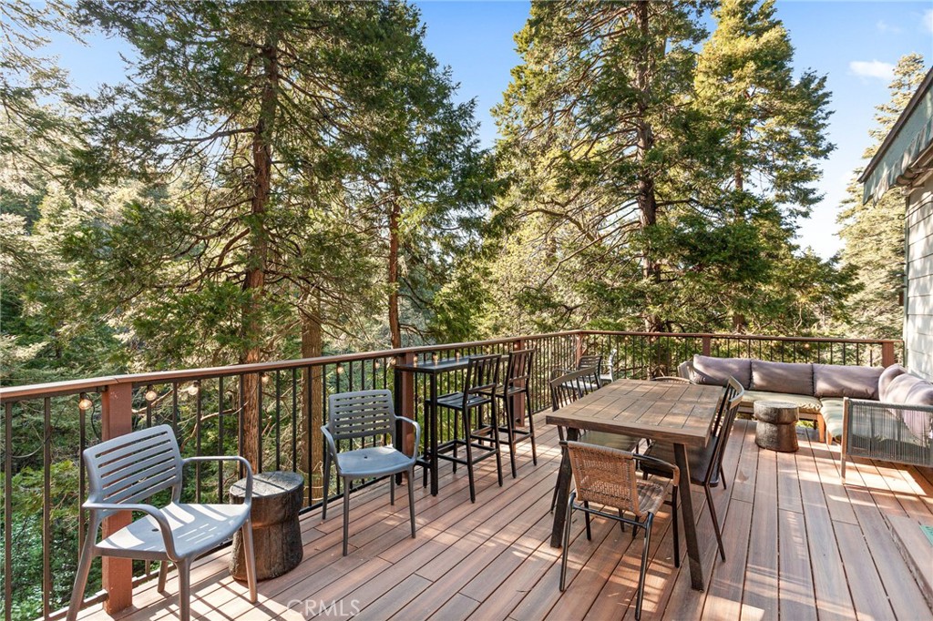 576 Kuffel Canyon Road Lake Arrowhead, CA 92352 - Photo 32 of 61 a view of a roof deck with table and chairs and wooden floor