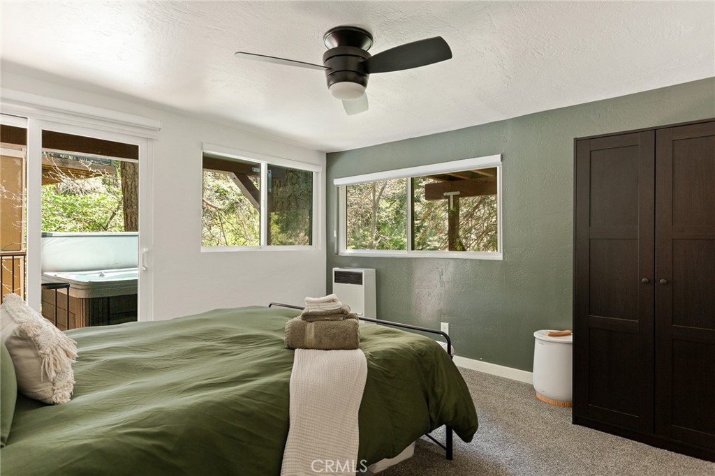 576 Kuffel Canyon Road Lake Arrowhead, CA 92352 - Photo 39 of 61 a bedroom with a bed and a window