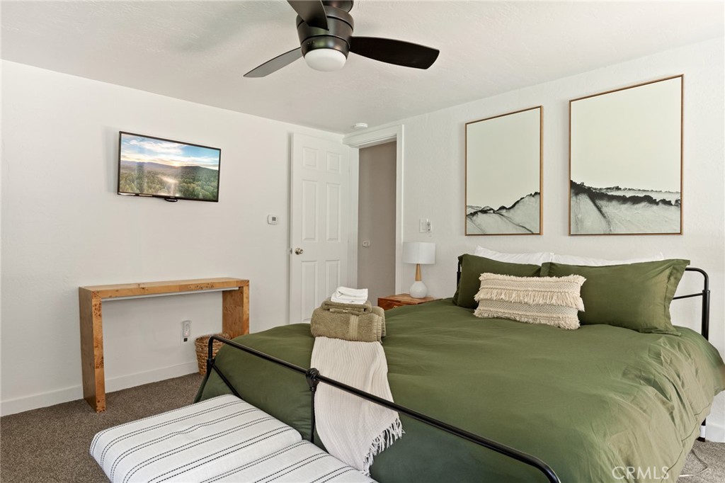 576 Kuffel Canyon Road Lake Arrowhead, CA 92352 - Photo 42 of 61 a bedroom with a bed and a painting on the wall