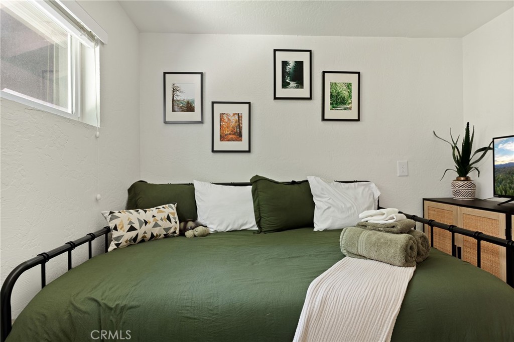 576 Kuffel Canyon Road Lake Arrowhead, CA 92352 - Photo 54 of 61 a bed room with a bed and a couch