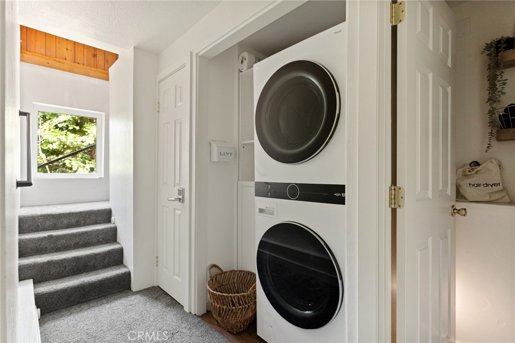 576 Kuffel Canyon Road Lake Arrowhead, CA 92352 - Photo 60 of 61 a view of a hallway with washer and dryer