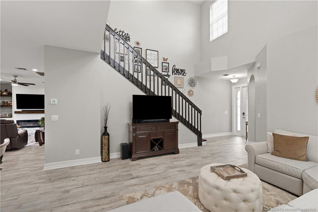 1268 Southeast Kirk Street Stuart, FL 34997 - Photo 20 of 63 a living room with furniture and a flat screen tv