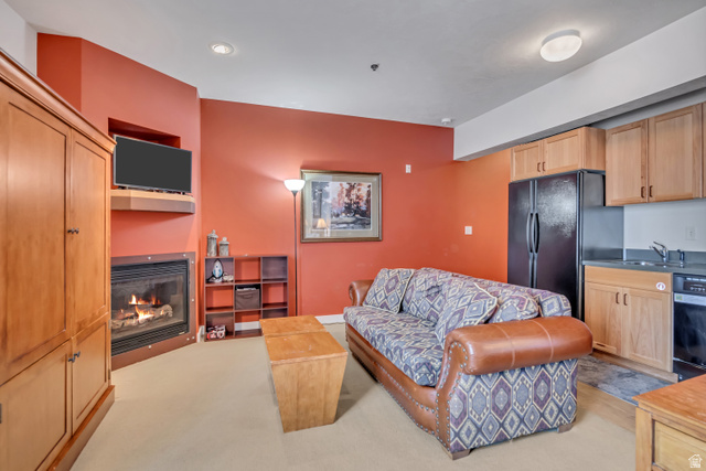 1364 Still Water Drive, Unit R3005 Heber City, UT 84032 - Photo 4 of 28 Living area featuring a glass covered fireplace and light colored carpet