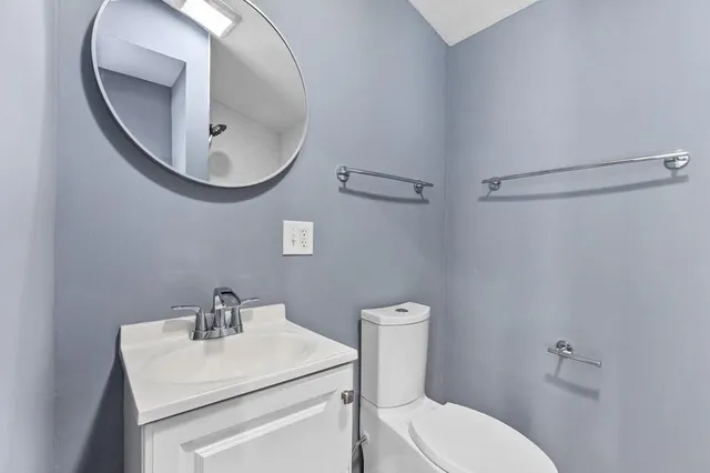 a bathroom with a sink a mirror a toilet and a mirror