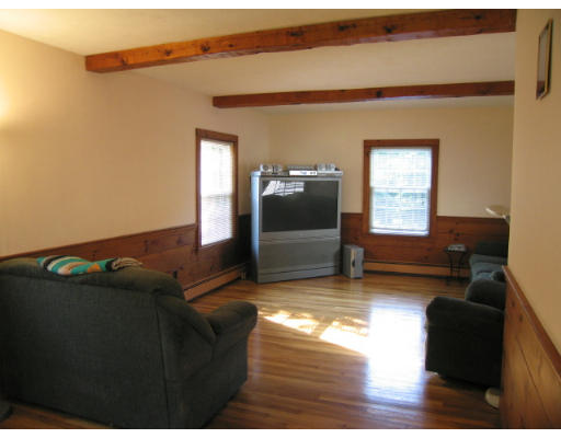 16 Booth Hill Road Scituate, MA 02066 - Photo 4 of 18 a living room with furniture and a flat screen tv