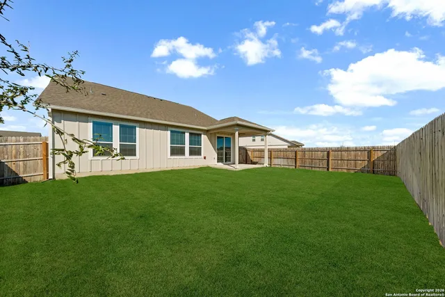 a view of a house with a backyard