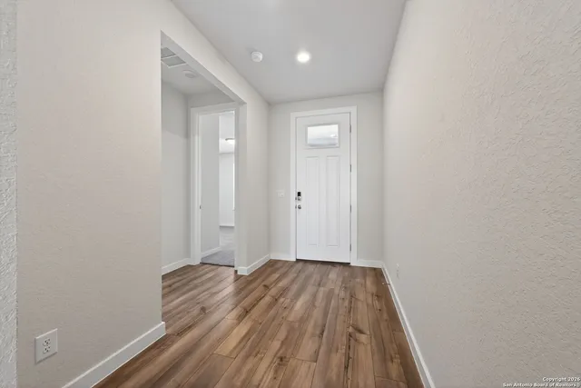 a view of hallway with wooden floor