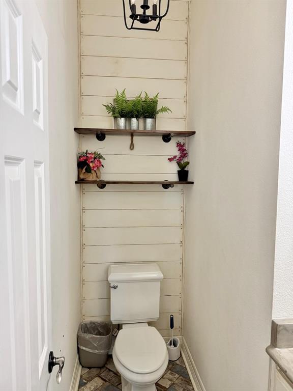 2300 Berend Road Pilot Point, TX 76258 - Photo 16 of 39 Bathroom featuring toilet and stone finish floors