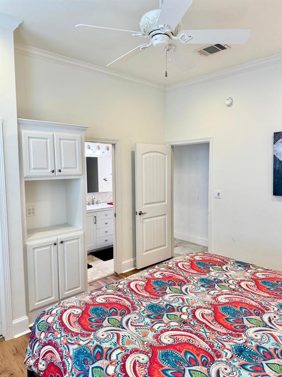 2300 Berend Road Pilot Point, TX 76258 - Photo 22 of 39 Bedroom with a ceiling fan, light wood-type flooring, ensuite bath, and crown molding