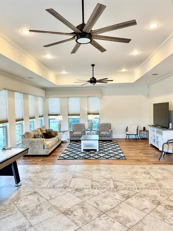 2300 Berend Road Pilot Point, TX 76258 - Photo 25 of 39 Living room featuring a tray ceiling, crown molding, ceiling fan, and recessed lighting