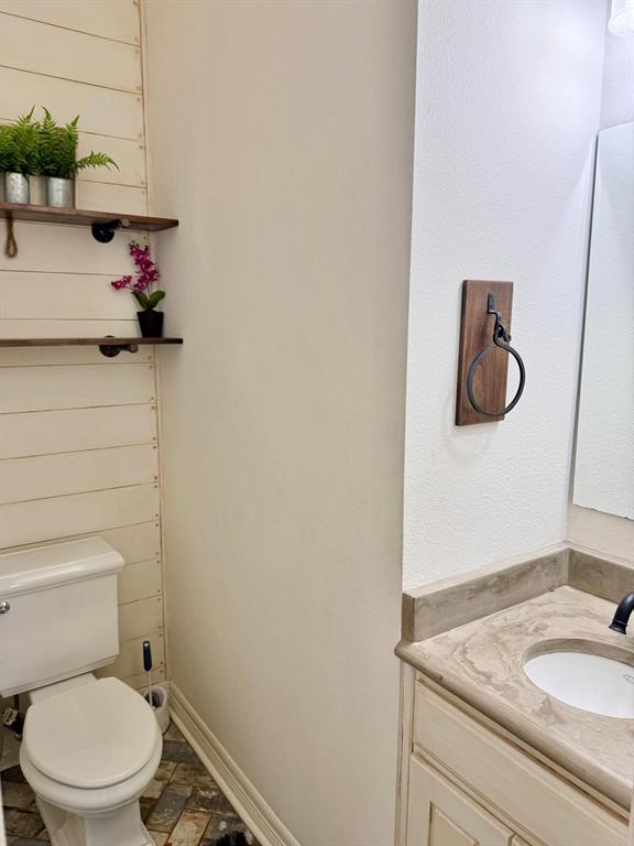2300 Berend Road Pilot Point, TX 76258 - Photo 26 of 39 Half bath featuring vanity and light stone finish floors