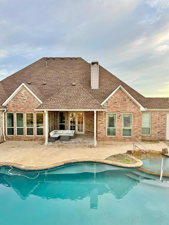 2300 Berend Road Pilot Point, TX 76258 - Photo 34 of 39 Rear view of property featuring a patio, roof with shingles, an outdoor pool, and outdoor seating