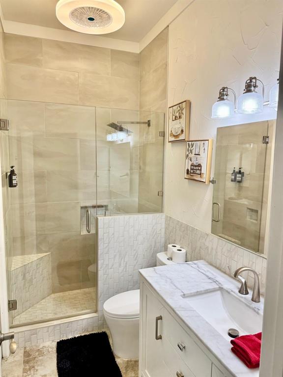 2300 Berend Road Pilot Point, TX 76258 - Photo 10 of 39 Full bath featuring vanity, a shower stall, and tile walls