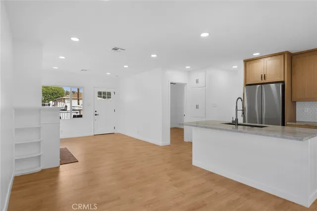 a view of kitchen with refrigerator and window