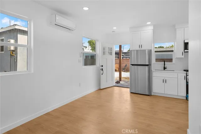 a kitchen with stainless steel appliances a stove a microwave and a refrigerator